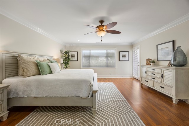 Expanded and permitted is this beautiful primary bedroom.  Crown molding, ceiling fan, and easy to maintain flooring.
