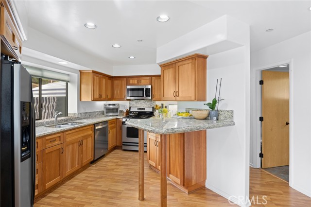 338 Y - Kitchen feature breakfast bar, abundant wood cabinetry and premium stainless steel appliances.