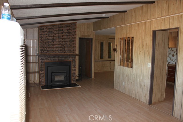 view of fireplace in living room to kitchen and dining room