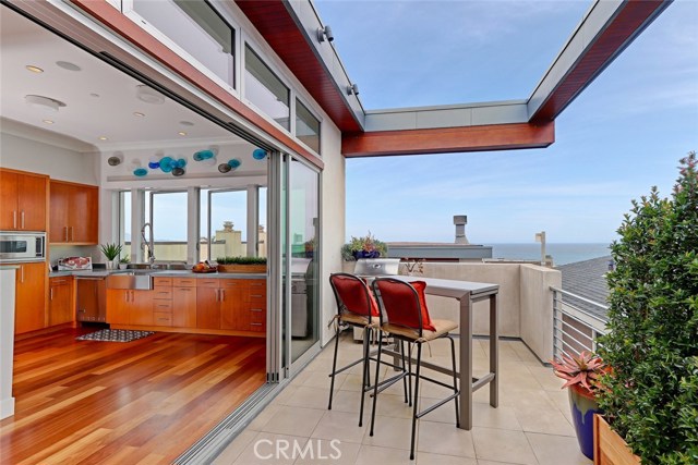 Outdoor Patio with Sliding Glass Walls and Ocean View