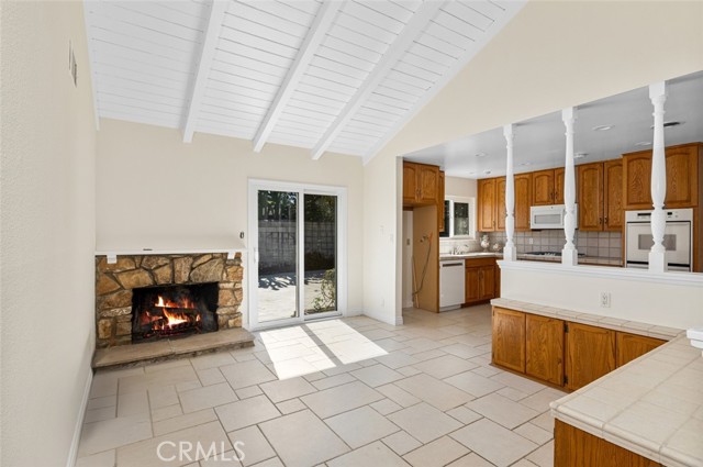 Family room has a pitched board and beamed ceiling which adds charm to the open feeling.