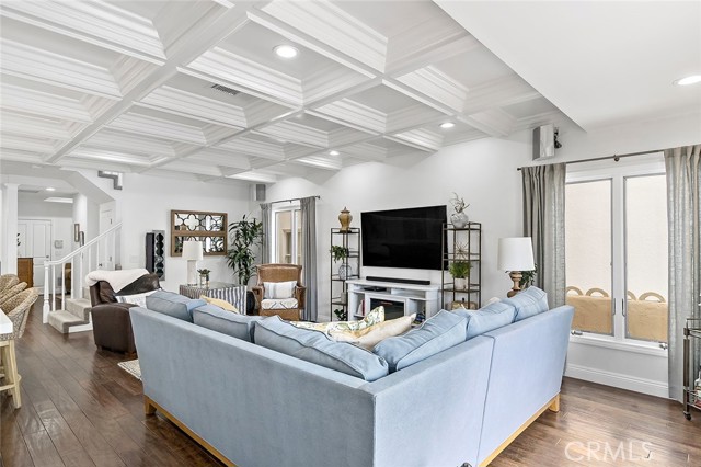 Coffered ceiling and black cherry wood flooring showcase the great room