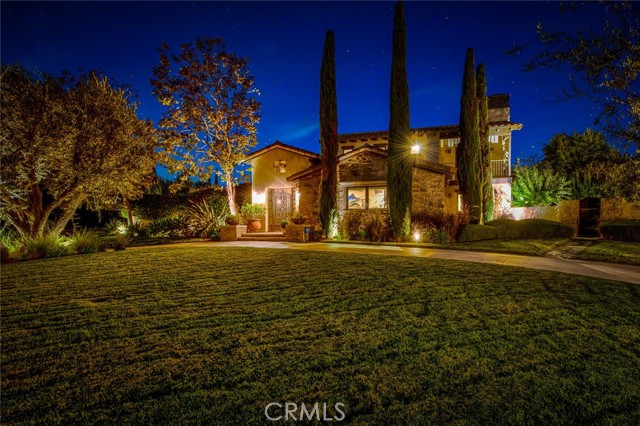 This Tuscan Farmhouse style embraces classical architectural style with modern elements for superb curb appeal and livability.  Situated on a corner with a slight rise in elevation and circular drive, this beautifully executed Tuscan country home was created for the connoisseur of fine living.  The exceptional landscape with cypress and olive trees compliments the natural stone and Tuscan elements.   A custom designed wrought iron gate and heavy arched door open to a vaulted atrium and very private courtyard complete with stone lintel leading to the inside of the home.  The upstairs Master suite offers two Juliet balconies, handsome wood flooring, antique farmhouse beams, two walk in closets, radiant heat in bathroom plus a custom “Diamond” brand copper jetted tub, natural stone waterfall in shower, plus a beautiful retreat with  fireplace for being cozy on chilly evenings.  On the main floor there are 4 bedrooms and baths including two ensuite bedrooms, one with direct access to the back yard.  The center island Chefs kitchen with all of the bells and whistles accommodates a large “farm” table for dining and multiple French doors to the outside with views of the sparkling poo.  A Custom automatic wooden gate to the side of the property opens to the motor courtyard and garage.   Venetian plaster, smooth plaster, authentic antique beams from a southern tobacco barn, a stunning outdoor fireplace with seating, built in BBQ island with seating, plus sparkling pool with huge spa and a putting green all combine to make this property the perfect refuge from a busy daily life.  This is a one of a kind property that will not be replicated anywhere else!