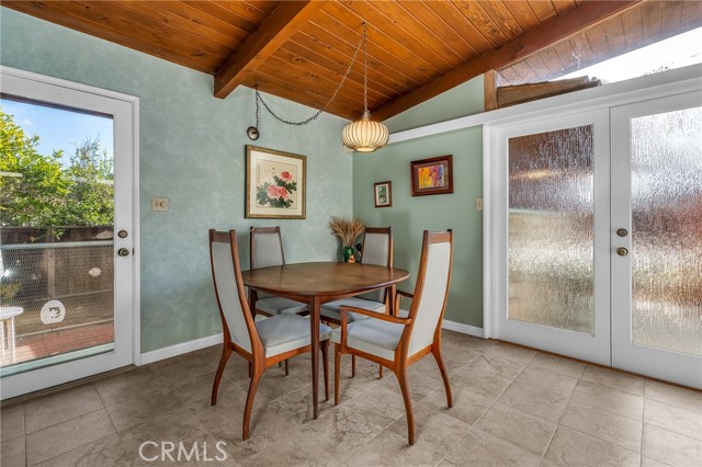 View of the door leading to the side yard, the didning area and the door leading to the front yard patio