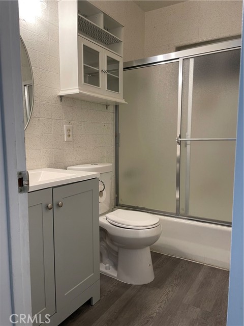 Full bathroom with new flooring, sink and toilet