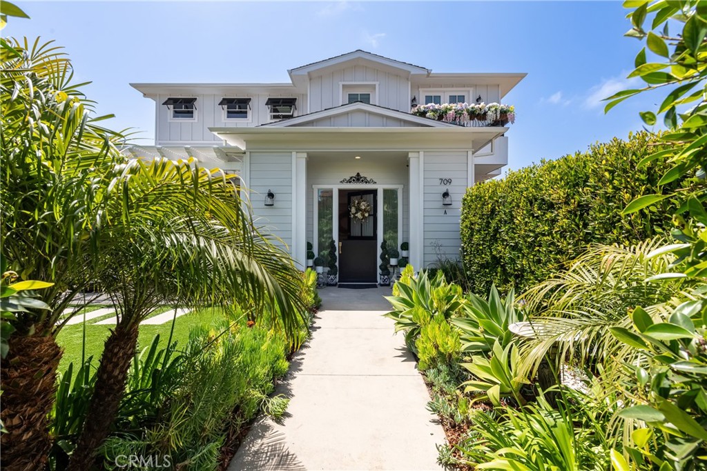 Elvira Avenue is a beautifully exclusive two-block stretch of tree-lined residences in South Redondo Beach, West of PCH and only two blocks from beach, sand and surf. 709 Elvira #A is a California Coastal Dream, a perfect match for the street in which it resides. Step into a private tropical front yard oasis lush with greenery and a large front patio that completely opens up into the dining room & kitchen through large glass accordion doors. Truly the most ideal summer set up for indoor/outdoor living as you, friends and family migrate between the beach, the outdoor BBQ, front yard games and indoor relaxing. No matter what your kitchen needs are, you’ll be thrilled to find an abundance of cabinetry, a massive center island with bar seating, stainless appliances, and 5-burner Italian range. Not to mention the second bar sink in the island, you’d be surprised how handy that can be. Open Floor Plan is the vibe with the kitchen opening up to the living room so you can catch the game while you cook, enjoy the stacked stone fireplace and pop over to the corner bar where your wine fridge is chilling up your next beverage. The beauty of this floorplan is in the tradition - all bedrooms are upstairs including a primary suite that’s an oasis of its own featuring another fireplace, space for your own sitting area, a luxurious primary bathroom and of course a very important outfitted walk-in closet. There’s a family room upstairs as well for secondary gathering space. The finale, the reason we love to live near the beach, head up to the roof and enjoy the spacious rooftop deck with an ocean peak view and space to enjoy dinner al fresco while the sun sets to the West or a cup of coffee while it rises in the East. While the home is exceptional, the location is hard to beat as well - restaurants, local grocers, shopping, coffee shops, walking paths, and everything in between all within walking distance. Very few people are fortunate enough to call Elvira their street, here’s your opportunity with the absolute dream home.