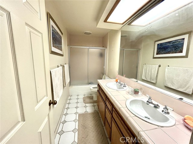 Full bathroom on entry level, double sinks and tub/shower