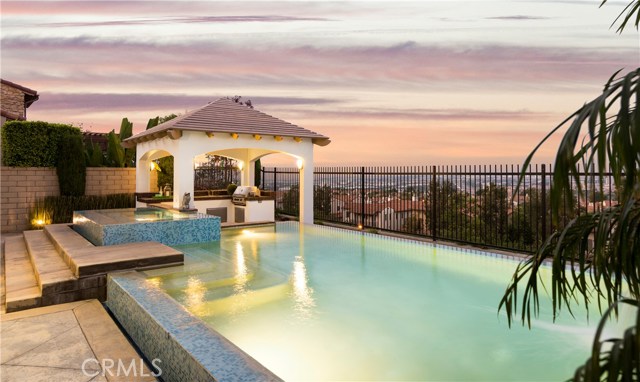 18 Dreamlight Irvine, California Ultra Modern 5 Bedroom Vicara Plan 2 estate with Infinity Pool located near the top of prestigious Quail Hill! Breathtaking panoramic views for miles! This home features modern and upgraded interior elements including a one-of-a-kind custom-built kitchen with contemporary finishes, gorgeous light fixtures, and designer paint. A chef's dream kitchen with a large center island, upscale stainless steel appliances opening to a spacious family room. Step out to an extravagant backyard featuring an incredible infinity pool, built-in sunken BBQ area, outdoor bar under a large patio covering. Private guest casita or office with its own en-suite bathroom and courtyard graced by a designer fountain. Stately master bedroom suite is nothing short of luxurious with its own balcony and view. Spa-like master bath features separate tub and shower with custom tiling, granite counter top sinks, and over-sized walk-in closets. Additional private bedroom suites offer generous space, ceiling fans, and tastefully appointed bathrooms. Homeowners can enjoy world-class amenities including tree-lined streets, hiking/biking trails, 3 Community Pools, 5 parks, Fitness Center, and pristine picnic areas. Alderwood Elementary in middle of Quail Hill, and within the award-winning University High School area of Irvine! Conveniently located near Quail Hill Shopping Center and world-class shopping. Easy access to the 405, 5, and 133 Freeways. Only minutes away from John Wayne Airport and Laguna Beach.