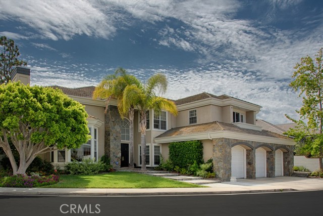 5 Rockingham Drive Newport Beach, California Remodeled custom home with hardwood plank floors in guard-gated Belcourt! A dramatic two-story entrance with spiral staircase opens to the formal living room with a marble fireplace up the 20ft ceiling. The updated kitchen features stainless steel appliances, stone countertops and custom cabinetry with seating at the island as well as room for a breakfast table. The kitchen opens to a generous family room which looks out on the pool. A wine closet in between the family and living rooms will store more than 300 bottles of your favorite vintages! The formal dining room easily seats ten guests. A downstairs bedroom suite is adjacent to the back staircase and laundry room. Write your next novel or just work in peace in the downstairs, private office which has a small closet, making this room flexible space as a 6th bedroom. The master suite has a romantic fireplace and sitting area overlooking the pool area. The master bath features a free standing bathtub, separate marble shower, a custom Carrera marble makeup vanity area, and dual sinks. Three additional upstairs bedrooms, one with its own private bathroom and walk-in closet. Additional hallway upstairs bathroom. The large lot features a private swimming pools and spa, gazebo, and built-in BBQ. Come home to Belcourt!