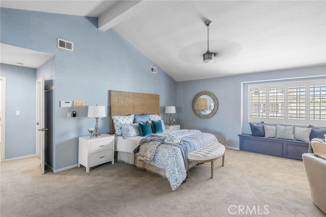 Owner's suite with window seat, ceiling fan.