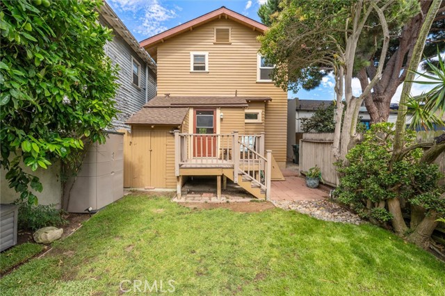 Back yard has 2 storage sheds plus a bump out storage area. Basement access to right of stairs.