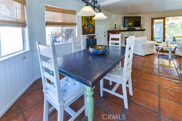 View from the breakfast nook with three windows to the left and view of the family room and private patio.