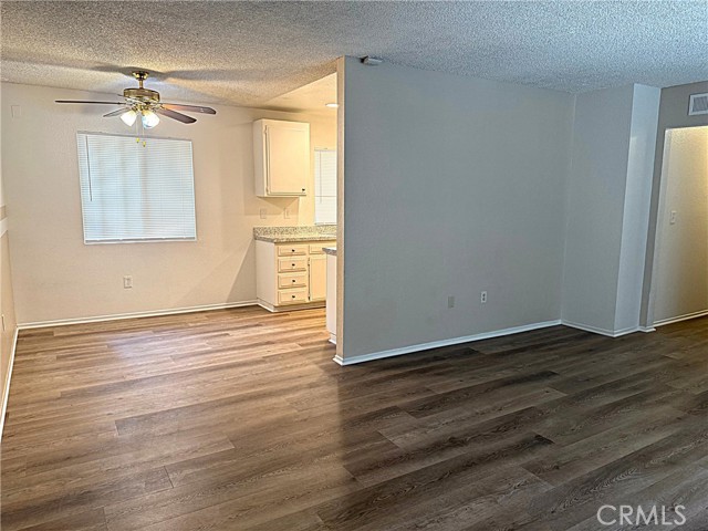 Living room opens into the dining area off the kitchen.