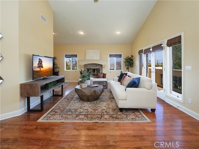 Fabulous living room with fireplace and lots of windows.