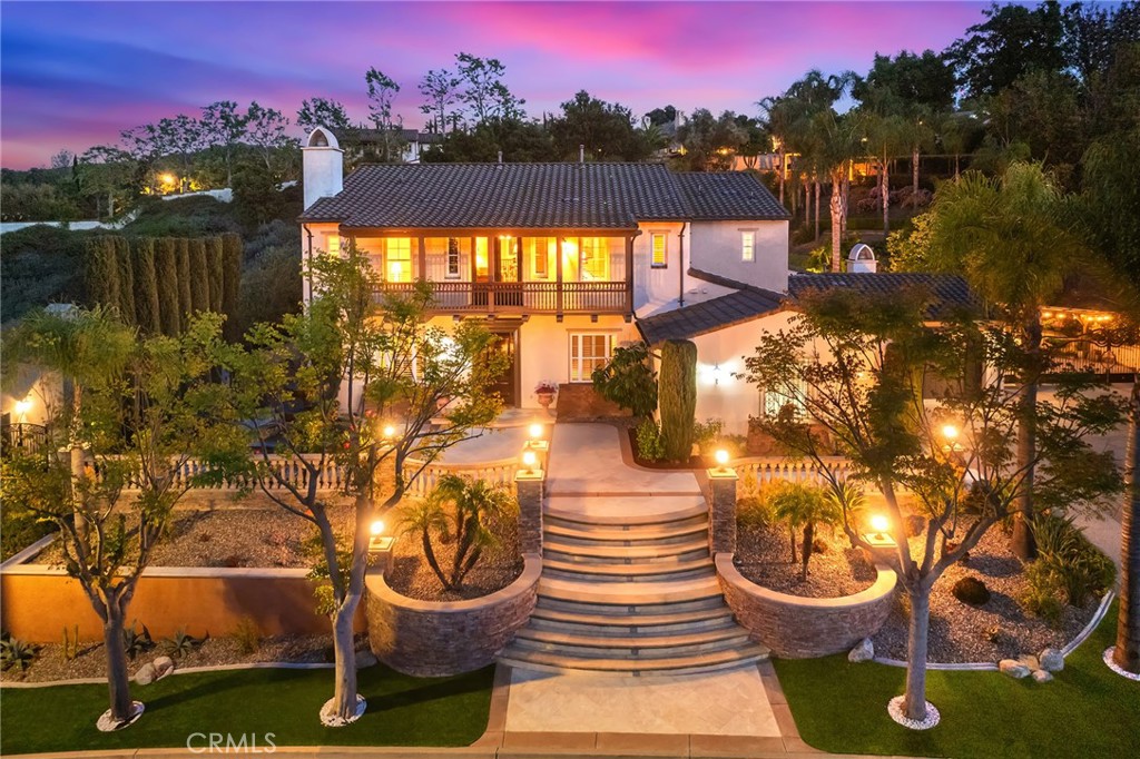 The Luxury semi-custom Spanish Colonial Style home in in the Gated Vellano community. It has 6 bedrooms and 6.5 Bathrooms (each bedroom has its full bath), of which 2 bedrooms and 2.5 bathrooms are located on the first floor, 4-car garage. There is also a bonus room upstairs. The primary suite has his and hers walk-in closets and a large private balcony to enjoy the mountain & city lights views. A welcoming fountain is in the front yard of the main entrance. The beautifully designed marble mosaics sit in the premium wood floor, which cover all the rooms. The living and family room has its own fireplace. The formal dining room has 2-story high cathedral ceiling and custom chandelier. Gourmet kitchen is equipped with the granite counter tops and high-end Appliances. Other notable features include customized curtains and wood shutters, crystal chandelier, recessed lights, ceiling fans, crown moldings, surrounding sound system, central vacuum, large driveway, water fountains, private side gate, RV parking, and 57 solar panels (Paid Off). The expansive backyard is a truly private oasis, designed for both relaxation and grand-scale entertainment.  Surrounded by mature palm trees, many fruits trees and lush greenery, the outdoor space features a sparkling swimming pool, spa, and customized water-creek with Koi Pond. A professionally manicured putt-green provides fun for golf enthusiasts, while the patios with string lighting creates a perfect setting for evening gatherings. Built-in BBQ Island with bar seating and a fireplace enhances the alfresco lifestyle. At the rear hillside, a charming pavilion with lighting offers a peaceful escape with elevated views of the landscaped grounds below ideal for morning coffee or twilight reflection with mountain and city lights views. Meandering garden paths lead to flower beds, water features, and cozy sitting areas. The overall ambiance is serene, elegant, and ready for entertaining under the stars. This extraordinary outdoor retreat seamlessly blends beauty and function, making it a highlight of this luxurious estate. It’s seamless space that comfortably flows for a luxury lifestyle. Cul-de-sac location, quiet and peaceful!