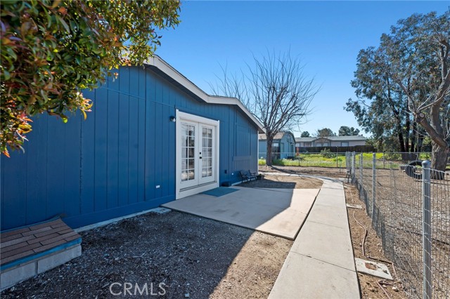 backyard showing double door to master bedroom