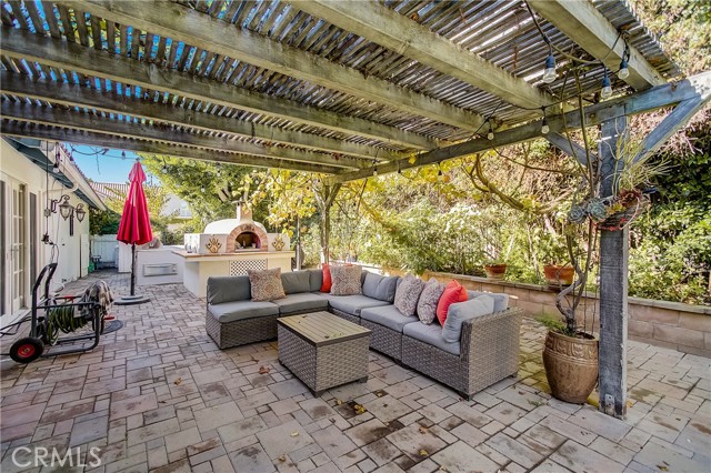 Side outdoor space with access to Family room, kitchen and formal dining room....the pizza oven is so wonderful!