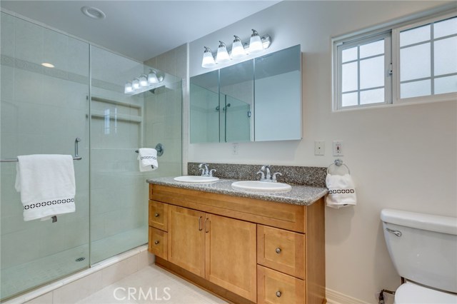 second master bathroom with double sinks and walk in shower