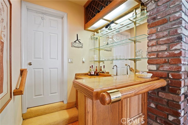 Wet bar is located by the living/room and has a step up to the Primary bedroom