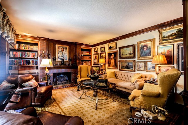 The well appointed Den is off the Entry and faces the Entry Courtyard with a cozy fireplace  and bookcases