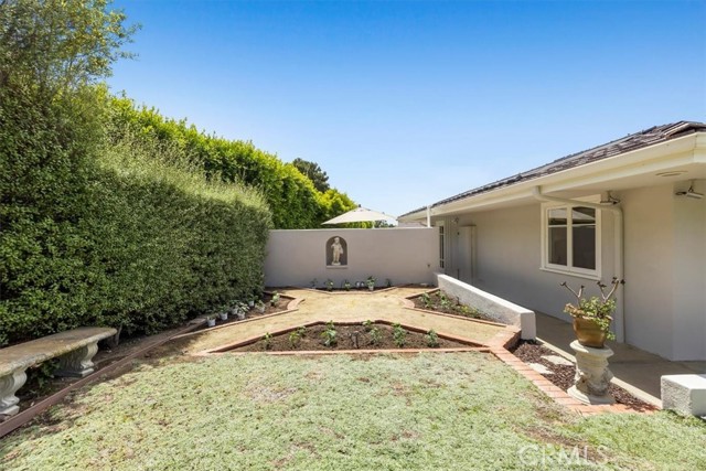 In the large side yard near the 4th bedroom Suite is a beautiful vegetable garden which was just replanted with nearly 40 vegetable producing plants.