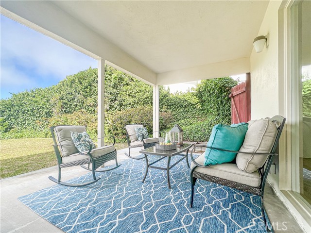 Outdoor patio next to large grassy area.