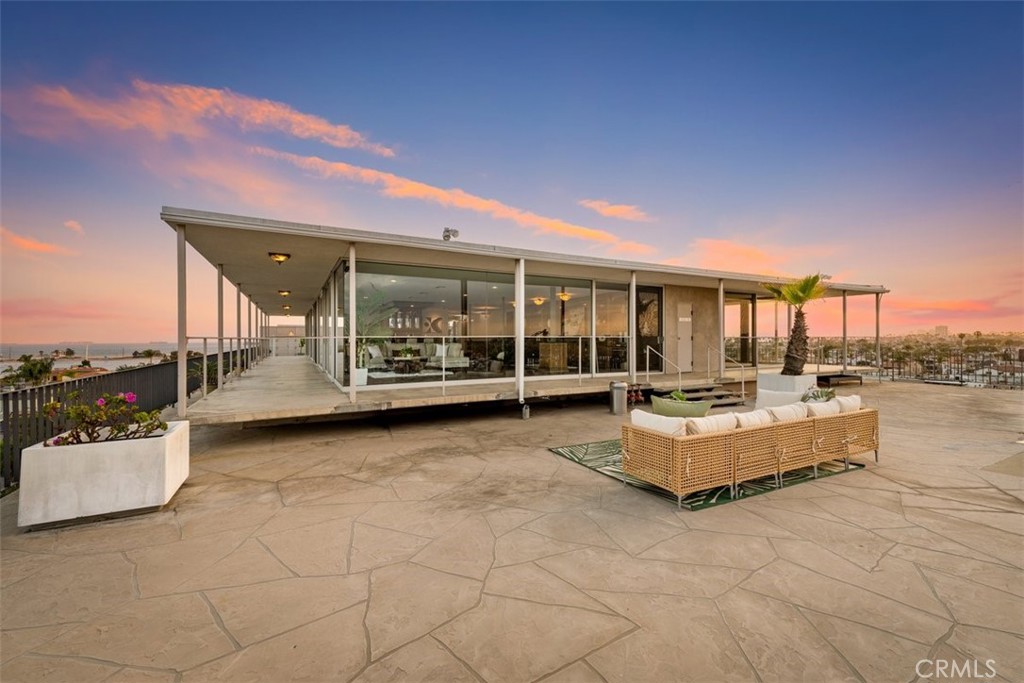 Perched atop the crown jewel of exclusive Naples Island, this extraordinary penthouse at the Portofino offers a rare opportunity to own a landmark residence in one of Southern California’s most coveted waterfront communities. Spanning approximately 4,000 square feet, this 3-bedroom, 4.5-bathroom masterpiece delivers commanding, unobstructed views of Alamitos Bay, the Pacific Ocean, city skyline, and distant mountains.  Positioned at the end of Belmont Shore’s iconic 2nd Street, the penthouse is just steps from premier dining, boutique shopping, and vibrant coastal culture—yet feels worlds away in its elevated privacy and serenity.  Designed with the entertainer in mind, this open-concept home seamlessly blends indoor and outdoor living. Expansive wraparound terraces provide the perfect setting for intimate dinners or large-scale gatherings, offering panoramic vistas that leave a lasting impression. Floor-to-ceiling windows flood the living spaces with natural light, showcasing the ever-changing scenery from every room.  Inside, the residence boasts a thoughtfully designed layout with grand living and dining areas, a gourmet kitchen tailored for both culinary precision and casual elegance, a stylish bar area, and dedicated laundry and fitness rooms. Two of the 3 spacious bedrooms offers its own ensuite bath, the third bedroom also enjoys a full bath down the hall, while an additional guest powder room adds convenience and sophistication.  Notably, this penthouse was once home to Hollywood royalty and is being offered for sale only for the second time since its original construction in 1962—underscoring its legacy and exclusivity.  A defining feature of the Portofino lifestyle is the private marina just steps from your door, offering seamless access to the water and an exclusive coastal living experience. Included in the sale is one boat slip accommodating vessels up to 30 feet—ideal for spontaneous bay cruises or sunset sails. Residents also enjoy a refreshing waterfront pool, perfect for relaxing after a day on the water or simply soaking in the serene bayfront ambiance.  And for one unforgettable night each year, the penthouse becomes the ultimate vantage point for the city’s dazzling July 4th fireworks, reflected across the bay in a breathtaking display.  With timeless elegance, unmatched views, and a location that combines vibrant city living with tranquil coastal charm, this is more than a residence—it’s a rare piece of Southern California history.