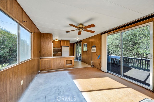 Living room opens to back deck with sliding glass door.