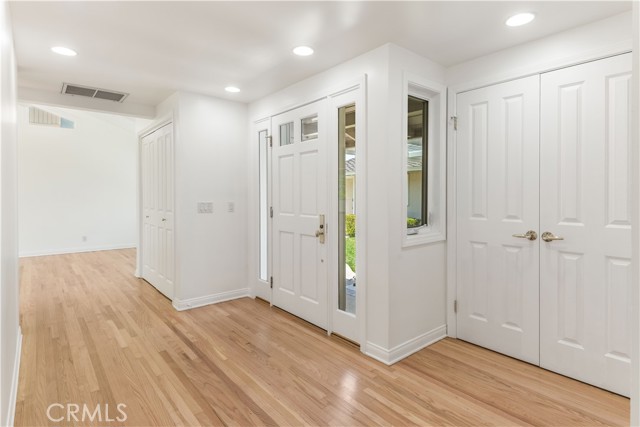 Entryway. Closest set of double doors is to a nice sized storage closet with built-ins.