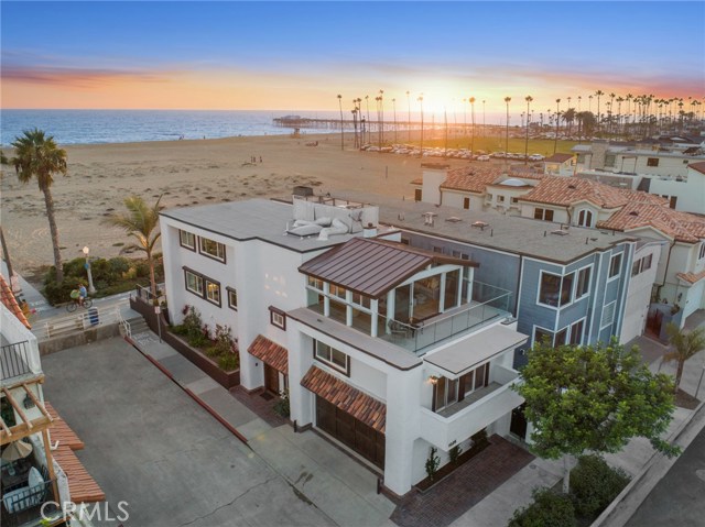 1025 E Balboa Boulevard Newport Beach, California Displaying arguably some of the best views along the boardwalk this light-filled, corner oceanfront home on Balboa Peninsula captures inspiring panoramic vistas up and down the coastline, as well as spectacular views of the bay front from the third floor solarium and deck. Zoned R2 with a short- term rental permit in place and a noteworthy vacation rental history this turn-key, fully furnished property holds endless possibilities. With a comfortable floor plan ideally suited for easy entertaining and casual beachfront living the four bedroom/four bath home benefits from the privacy afforded by its very unique elevated corner lot orientation. Stunning sit down views can be enjoyed from the living, dining and kitchen areas. The residence enters on grade - without any stairs - and boasts a desirable entry level, en-suite bed and bath, sauna, library, and 700 bottle, temperature-controlled wine cellar. A custom designed residential elevator provides easy access to all three levels of the home. The third floor master suite revels in captivating white water views and romantic Catalina sunsets. A newly completed veranda room with adjoining terrace offers exceptional views of Newport Harbor and the twinkling city lights beyond. Live the beach lifestyle. Enjoy al fresco dinners on your oceanfront patio. Take a stroll to the Balboa Island ferry, and myriad local shops and restaurants. Tool around Balboa in the golf cart that is included. It is vacation everyday!