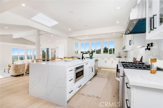 An open-concept island kitchen with breakfast bar and a complete line of preferred appointments and appliances.