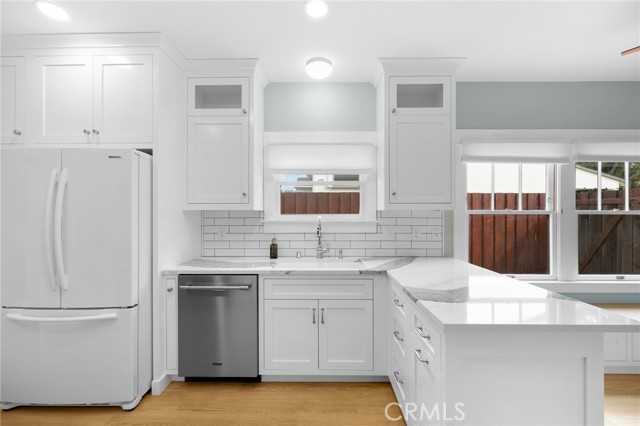 Remodeled Kitchen with breakfast bar, recessed lights, breakfast nook, quartz counters