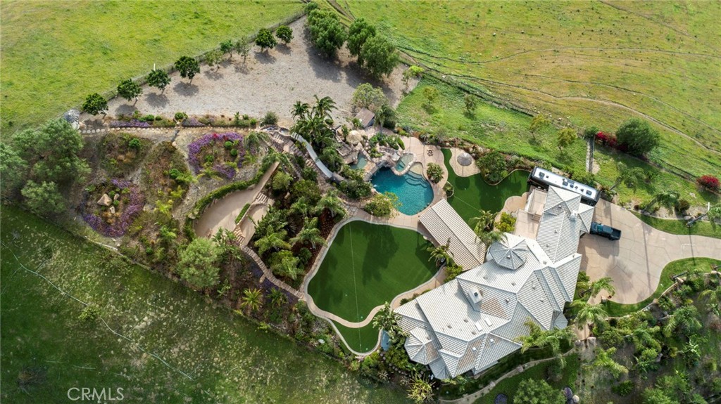 This amazing custom built estate is located on 2 of the most incredible acres you will ever see. The breathtaking panoramic  views of Catalina, city lights, sunsets and surrounding hills are truly magical.  When entering the gates you immediately know you are in for a special treat. The privacy and views high atop Copa De Oro are unlike anything else. When entering the foyer, the sheer size and openness of the home is impressive.  The nearly 7,000 square feet has 5 bedrooms 5.5 baths, library, office and movie theater.  The gourmet kitchen has custom cabinetry, granite counters, Thermador appliances and the oversized island makes this perfect for entertaining.  The ground have been meticulously maintained and make you feel as if you are living in an amusement park. The pool has 3 waterfalls, 2 beaches, spa and a massive water slide.  The covered patio with built-in barbecues is also another great place to entertain and take in the sights and surroundings.  The 6 car garage/workshop also has full RV hookups is perfect for any car or monster garage lover. And all this privacy is just minutes from Brea's award winning schools, Whole Foods, fine dining, theaters and Down Town Brea.