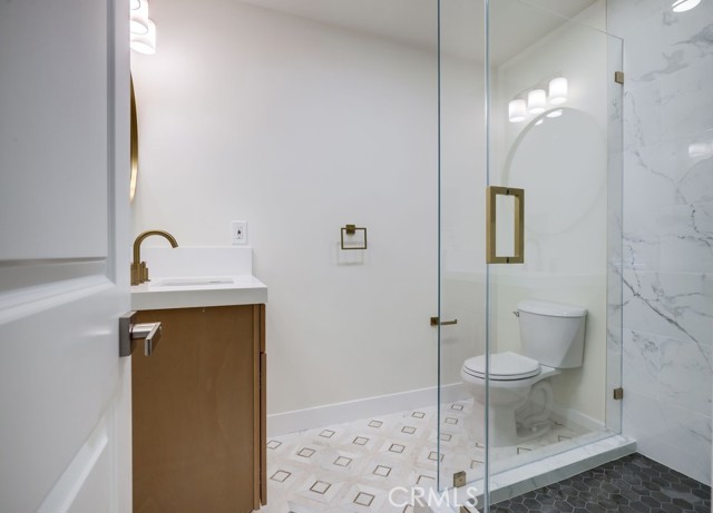 Bathroom #3 Downstairs Thoughtfully designed Tiled Shower with Custom Glass enclosure. Custom Elegant Floor Tile, New Cabinetry, Quartz Countertop, Mirror, Sink, Faucet and Hardware.