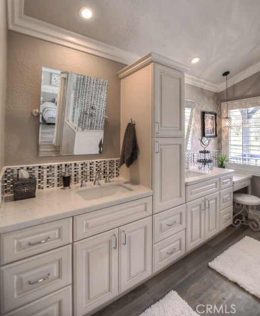 Plenty of sparkling white cabinets and drawers in the Master bathroom.