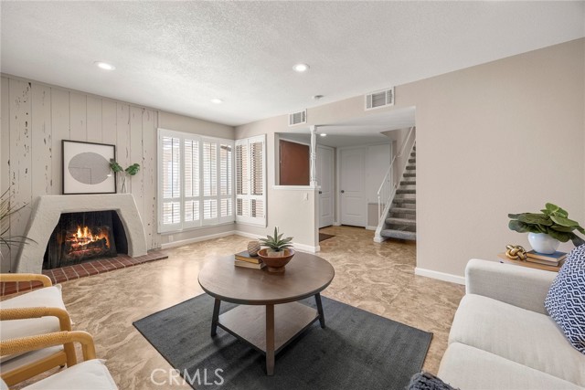The inviting living room features a cozy fireplace, while the family room flows seamlessly into the kitchen.