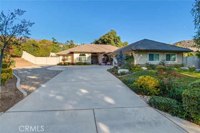 13033 Mesa Grande Drive Yucaipa, California This fabulous Wildwood Canyon, single story pool home has the prettiest natural setting. Big Oaks to one side of the lot, a beautiful pebble-tec pool with raised spa and a spacious deck, all blending into the natural mountain feel. Tastefully upgrade and remodeled, this 3 bedroom, plus an office layout features, an open great room, with natural rugged, destressed beams, wide plank laminate flooring, plantation shutters, new windows and new fixtures. The kitchen has shaker style cabinets, pull-out shelving, a massive center island with bar seating, exquisite light granite counter tops, a deep double sink, stainless steel appliances, including a commercial grade stove and an additional oven. A good size eating area in the kitchen and a formal dining room create terrific gathering spaces. The Master Retreat is spacious with walk-in closets, a spa size bath with dual vanities, soaking tub and separate shower. Inside laundry with a sink and finished garage, The full length Alumawood patio cover has insulated sections with built-in lighting and latticed open sections for natural lighting. Great entertaining spaces with the huge patio, pool with decking and natural open spaces for gatherings. Cute storage shed, gated RV parking with a dump and all nicely landscaped. This home will check off all of your boxes!!