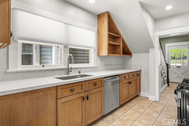 Beautiful kitchen with new quartz countertops, stainless sink and new stainless appliances. Finishing touches like custom storage cabinet and stove vent cover.