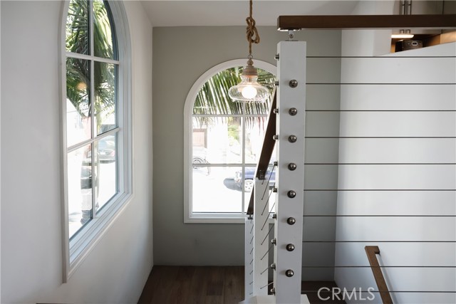 Very bright stairway with over-sized arched windows