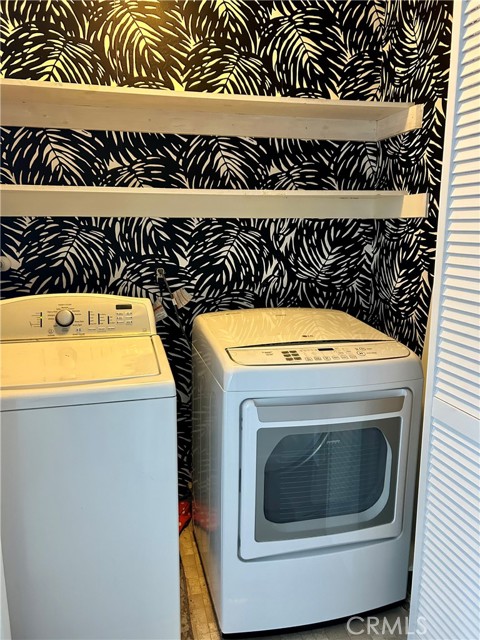 Laundry closet is upstairs with the two bedrooms with this fun Serena and Lily wallpaper!