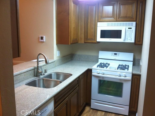 Solid wood cabinets. White appliances