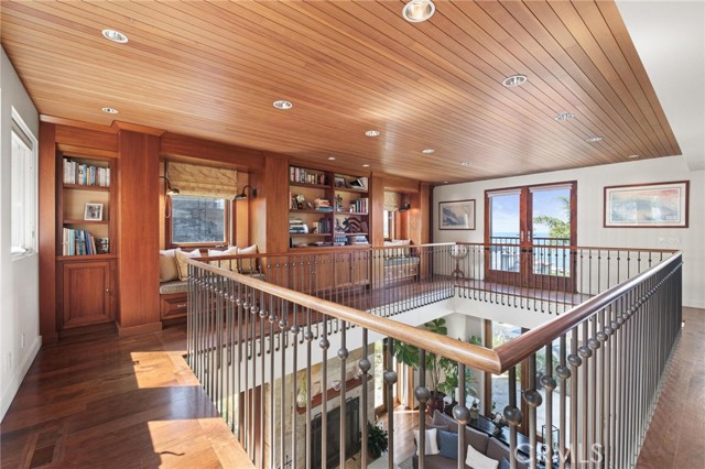 Second floor library with ocean views, wood capped bronze railings and Douglas Fir tongue and groove ceilings