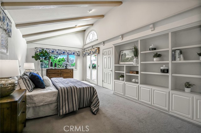 Primary bedroom has a west facing bay window that looks above the tree tops and beach