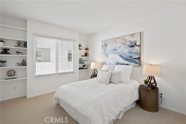 The second bedroom with large closet space also feature built-in bookcases.