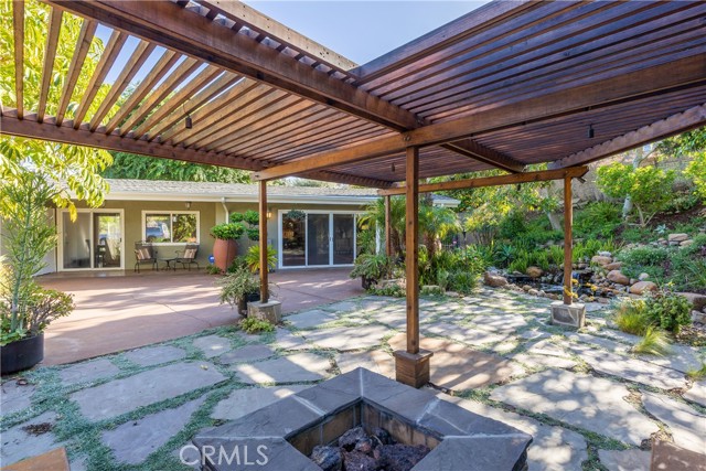 Be ready for the warm days and cool nights of the Palos Verdes Peninsula in an ambiance of paradise under the pergola covered conversation seating around the natural-gas fire pit.