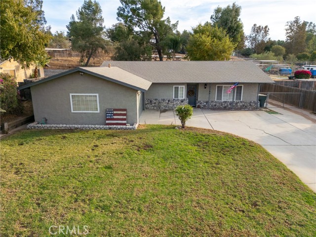 VIEW OF FRESHLY PAINTED EXTERIOR WITH ROOM FOR MANY CARS IN THE DRIVEWAY AND ACCESS TO THE FAR BACK OF THE PROPERTY ON THE SIDE.