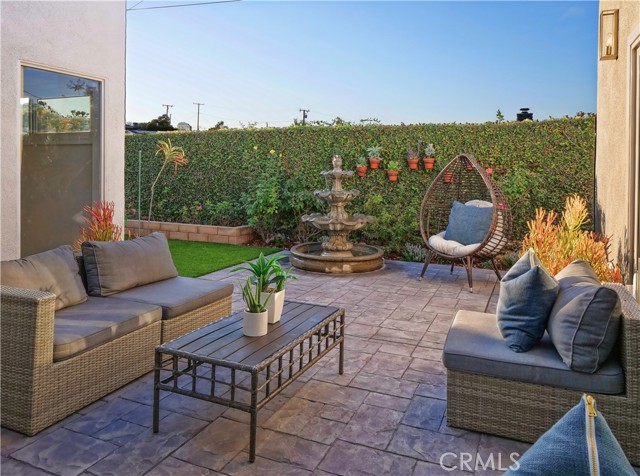 Secluded Backyard with new concrete patio and sculpted fountain