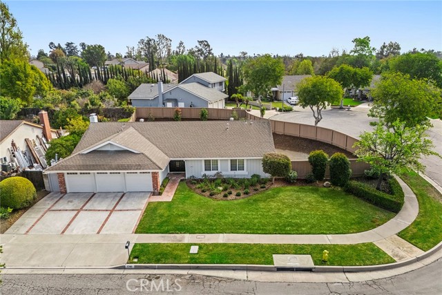 Welcome to this beautifully remodeled single-story home, perfectly positioned on a spacious corner lot in a peaceful cul-de-sac. This charming residence features 4 bedrooms and 2 remodeled bathrooms, with a bright and airy layout enhanced by vaulted ceilings and stylish LLP flooring throughout. The inviting open-concept living space includes a cozy brick fireplace and expansive windows, allowing for an abundance of natural light and seamless indoor-outdoor living. The updated kitchen boasts new stainless-steel appliances and a picturesque view of the lush backyard.  Step outside to a brand-new covered patio, ideal for entertaining or relaxing while overlooking the expansive backyard. Additional highlights include a three-car garage, hardwired security system, and a prime location in the highly sought-after Laguna Road Elementary, Parks Jr. High, and Sunny Hills High School district. Close to parks, hiking/biklng trails,  shopping, and dining, this is a rare opportunity to own a turn-key home in one of Fullerton’s most desirable neighborhoods!