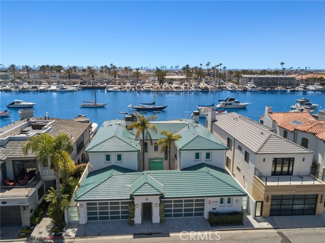 319 Via Lido Soud Newport Beach, California Are you in search of the “uber cool” and “ultimate fun” 12-month unfurnished lease? This Lido Isle bayfront home, on an extraordinarily large 60’ double lot, with a boat dock for two large yachts, and featuring spectacular Newport Harbor views is in move-in ready condition. The 4,600 square foot home with perfect southwestern exposure, features a large living room with a double-sided fireplace, formal dining room, media area with a built-in bar, keg refrigerator, ice machines, and a high-definition television, and a big island kitchen with granite countertops, professional grade stainless steel appliances including a coffee maker, six burner cooktop, double oven, trash compactor, wine refrigerator, Subzero Refrigerator, icemaker, dishwasher and so much more. In addition, the lower level has a large laundry area with two sets of washers and dryers, and a three-car attached garage. The lower level is highlighted by the huge bayfront patio with a built-in entertainment center, sit down countertop bar, BBQ, refrigerator, Jacuzzi and more. The upstairs of the home features a huge bayside master suite with an office or retreat, fireplace, private balcony, stunning bath with a jacuzzi, sauna and walk-in closet, and a big guest suite with a marble bath and vanity. The big dock can accommodate two large boats, one potentially to 70’ and a side-tie. Lido Isle is the ultimate lifestyle community with its private beach club, sailing, tennis courts, parks and activities for all ages. This property is within an easy walk of the new Lido Village with its upscale shops, restaurants, and nightlife.