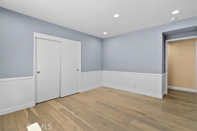 Super clean 2nd Bedroom with wainscotting and hardwood floors